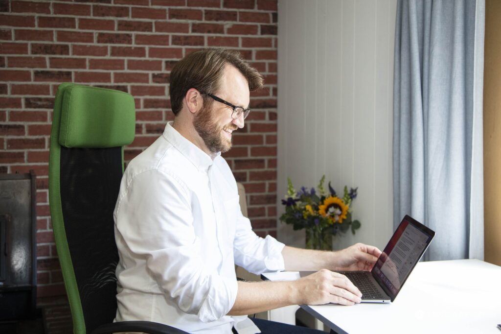 picture of Jesse Kauffman, LMSW seated working on a laptop